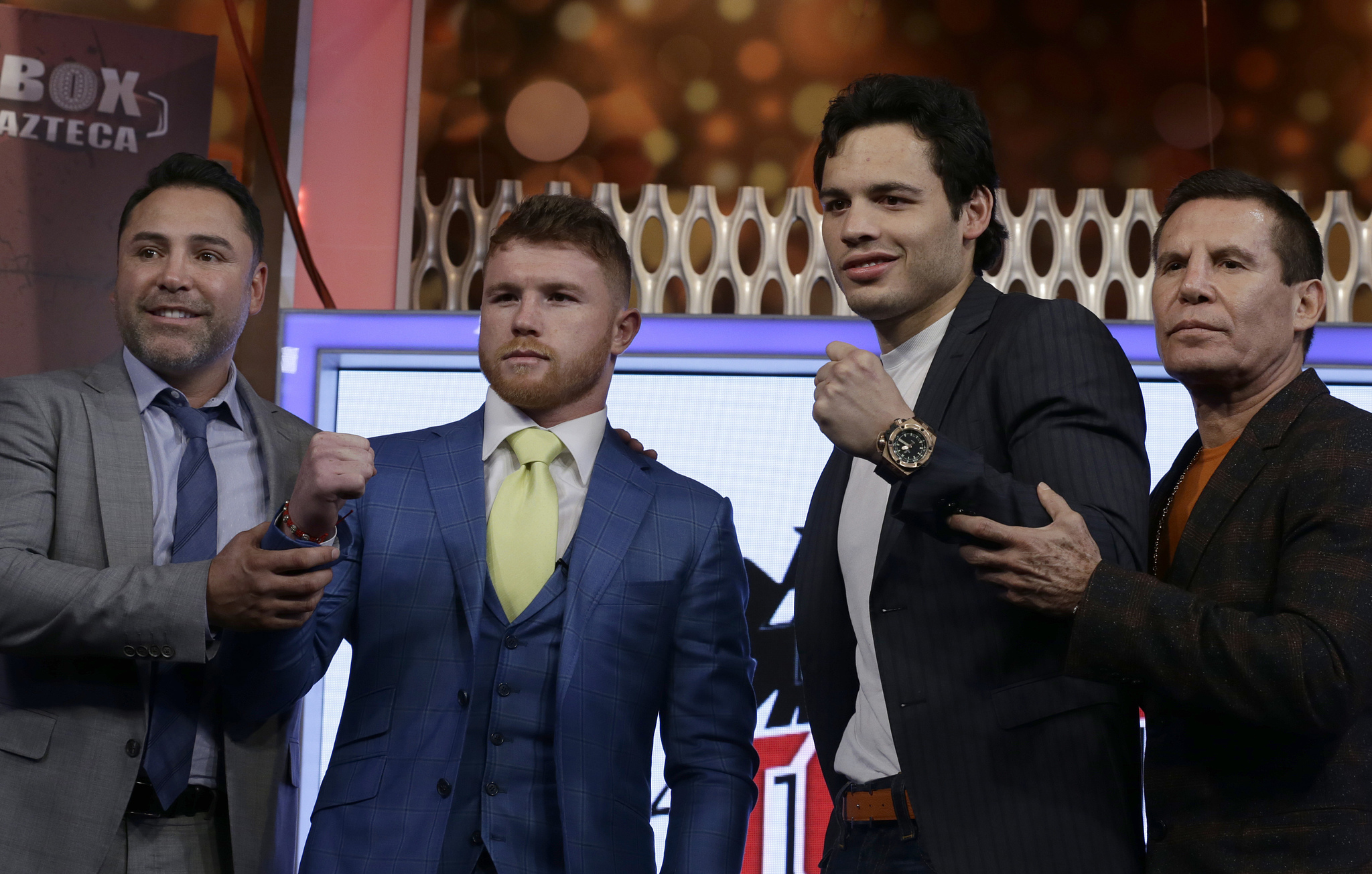 Mexican boxers Saul Canelo Alvarez, second left, and Julio Cesar Chavez Jr., second right are presented during a press conference. Also pictured are Hall of Fame boxer Oscar De La Hoya, left, and Julio Cesar Chavez