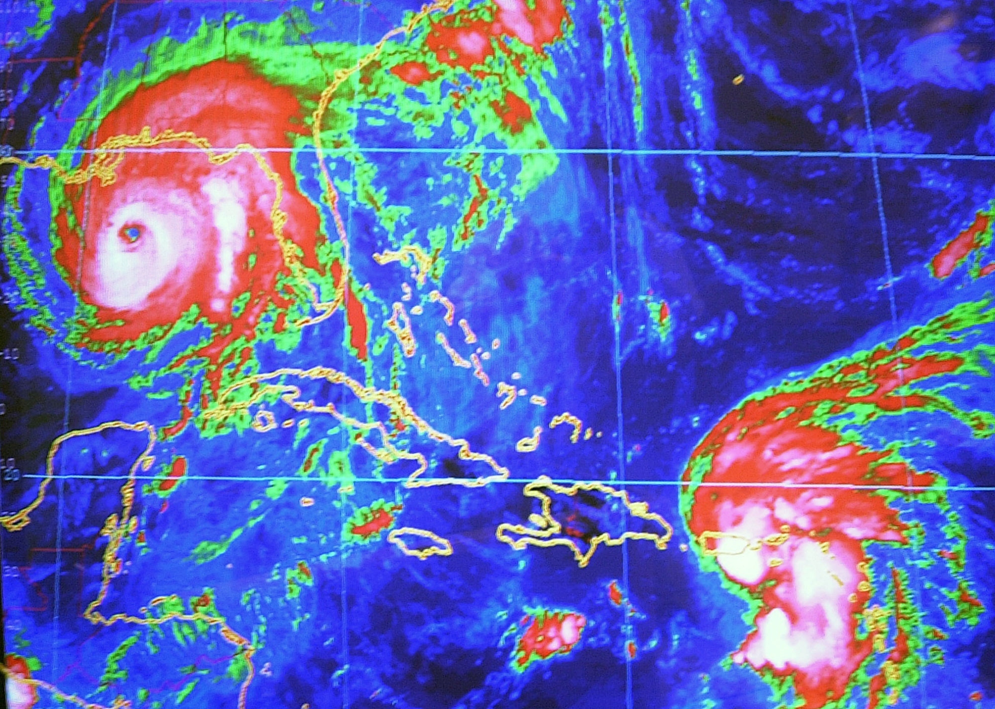 Hurricane Ivan seen on the computer screen at the National Hurricane Center in Miami, Wednesday, Sept. 15, 2004 seen 250 miles from the Gulf Coast and Tropical Storm Jeanne is seen as approaches Puerto Rico.