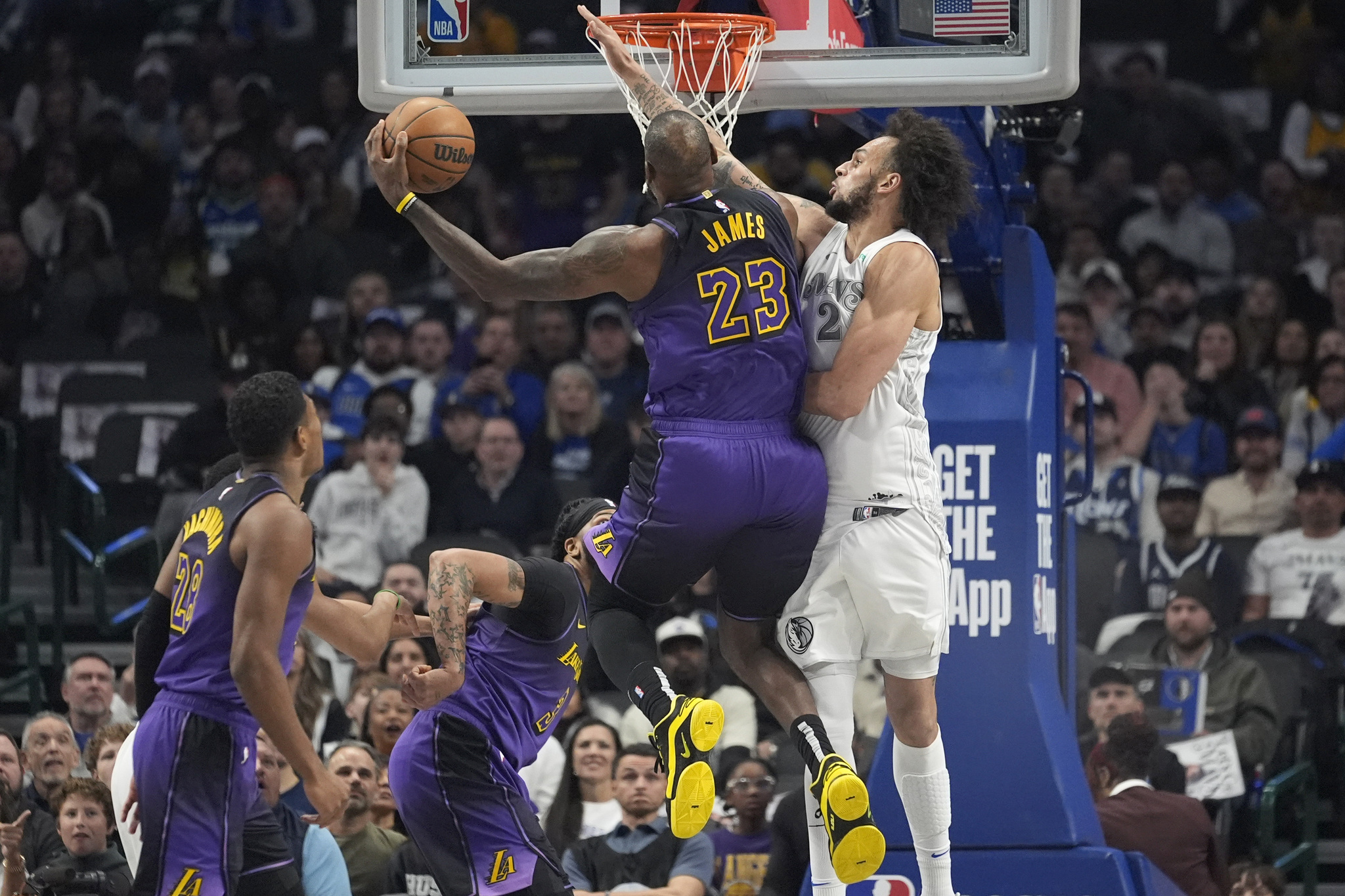 LeBron James (23) drives to score against Dallas Mavericks center Dereck Lively II (2)