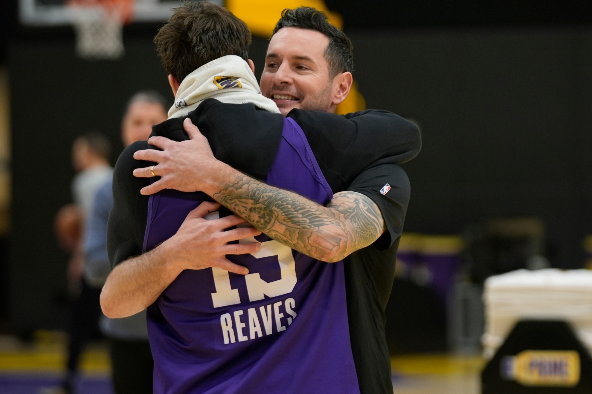 JJ Redick is hugged by Austin Reaves during a Los Angeles Lakers practice.