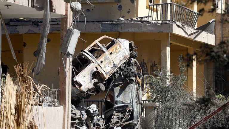 Destroyed vehicles between houses in a residential district at the frontline in Raqqa