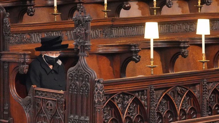 Britain's Queen Elizabeth II takes her seat for the funeral of Britain's Prince Philip, who died at the age of 99, at St George's Chapel, in Windsor, Britain, April 17, 2021. Victoria Jones/Pool via REUTERS