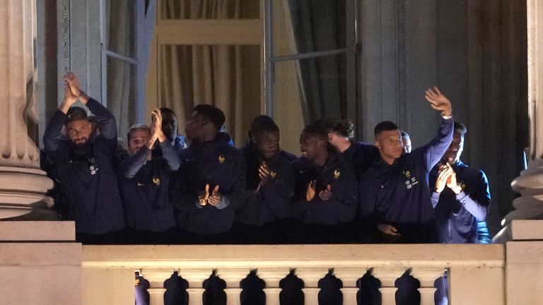 French players, Olivier Giroud, left, Antoine Griezmann, second left, Kylie Mbappe, right, and teammates wave at the balcony of the Hotel Crillon, Monday, Dec. 19, 2022 in Paris. Fans welcomed the France team in central Paris after its World Cup final match loss against Argentina. (AP Photo/Francois Mori)