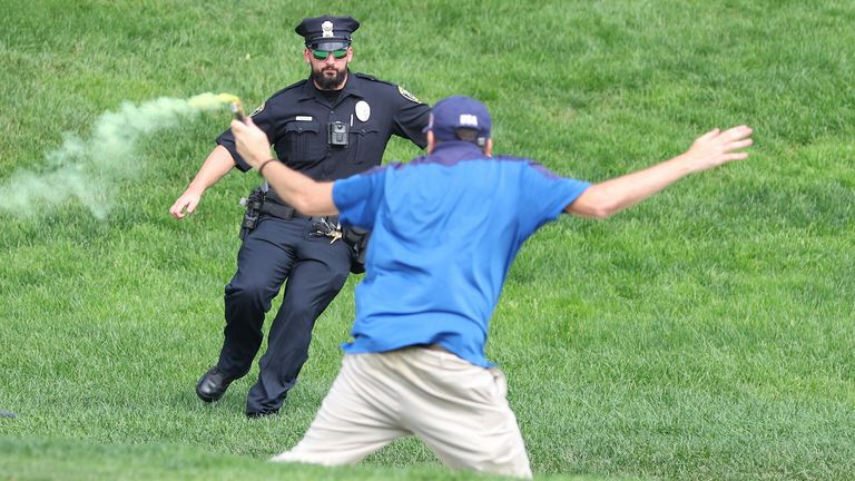 CROMWELL, CT - JUNE 23: Protesters run onto the 18th green during the final round of the 2024 Travelers Championship on June 23, 2024, at TPC River Highlands in Cromwell, CT. (Photo by M. Anthony Nesmith/Icon Sportswire) (Icon Sportswire via AP Images)