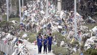 Students walk past the debris, mostly plastic waste dumped into the river by the people, as the flood water recedes from the bank of Bagmati river following the deadly flood due to heavy rains, in Kathmandu, Nepal.
Pic: Reuters