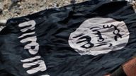 A fighter from the Christian Syriac militia that battles the Islamic State group under the banner of the US-backed Syrian Democratic Forces, burns an IS flag. (AP Photo/Hussein Malla, File)