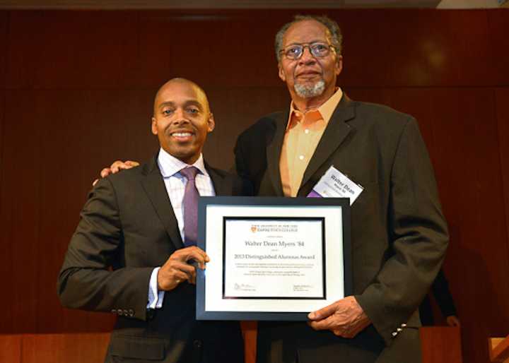 Khalil Gibran Muhammad, left, director of The Schomburg Center for Research in Black Culture, a research unit of The New York Public Library, presents Walter Dean Myers with the 2013 Distinguished Alumni Award.