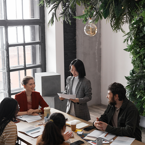 A diverse team of professionals discussing ideas and working together at a conference table in an office setting