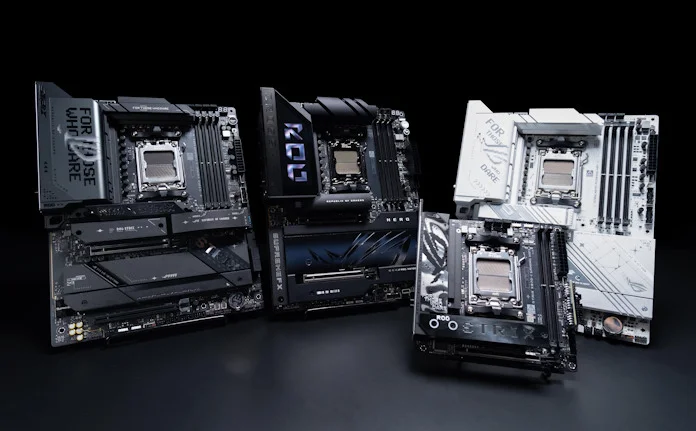 Four ASUS X870E/X870 motherboards arranged on a table