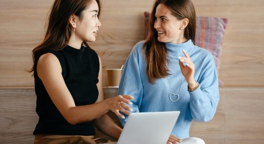 Business women with laptop talking about work