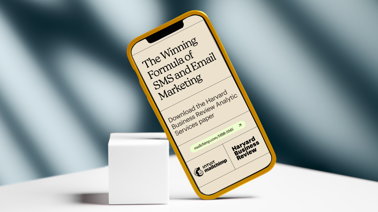 Mobile device showing the cover of the Harvard Business Review report with the title ‘Engage, Convert, Repeat: The Winning Formula of SMS and Email Marketing’