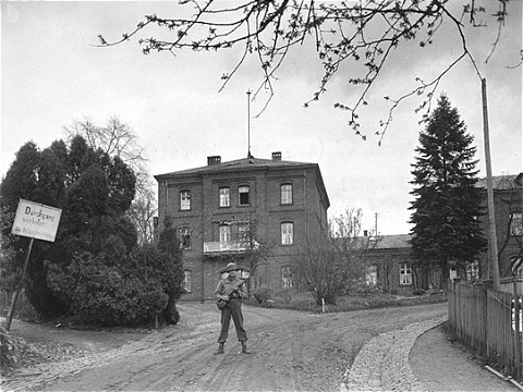 An American soldier stands guard in front of the Hadamar Institute. [LCID: 08474]