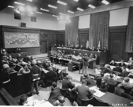 American Major Frank B. Wallis (standing center), a member of the trial legal staff, presents the prosecution's case to the International ...