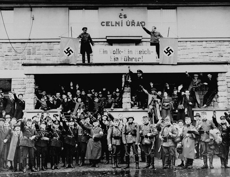 German troops marching into the Sudetenland stop at a former Czech frontier post.