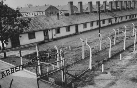 View of the kitchen barracks, the electrified fence, and the gate at the main camp of Auschwitz (Auschwitz I).