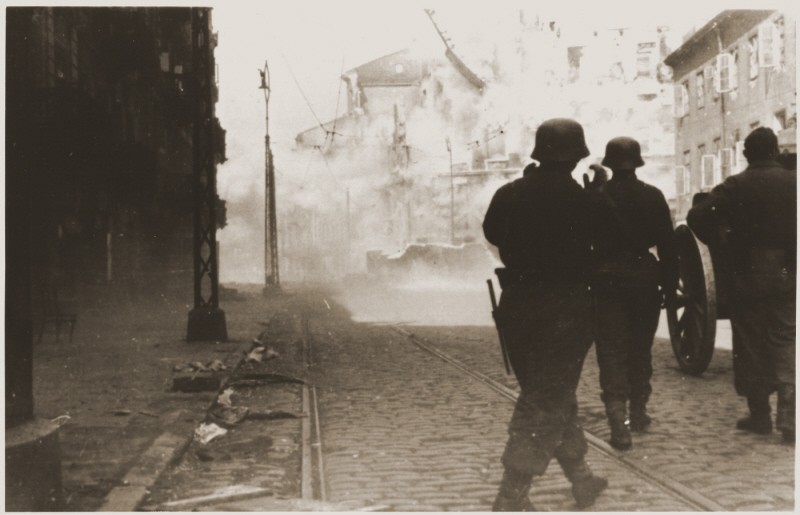 German soldiers direct artillery against a pocket of resistance during the Warsaw ghetto uprising.