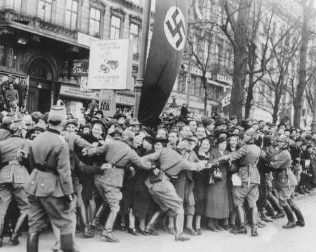 Cheering crowds greet Hitler as he enters Vienna.