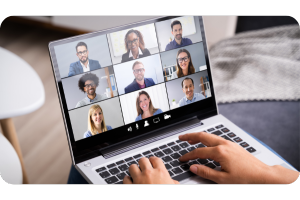 laptop screen showing online meeting with multiple participants