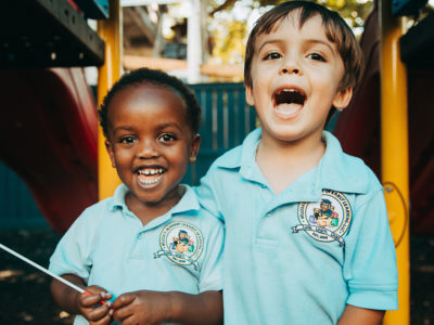 picture of two children - one black and one white - posing for a picture. Racial inequities is at the forefront of many conversations in New Orleans