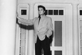 lvis Presley leans against a massive pillar on the front porch of his traditional southern-style home, Graceland at Whitehaven, near Memphis.