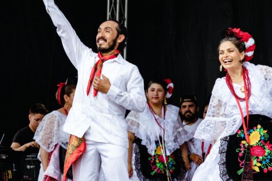 People in traditional clothes dance at Cinco de Mayo on Cherokee Street.