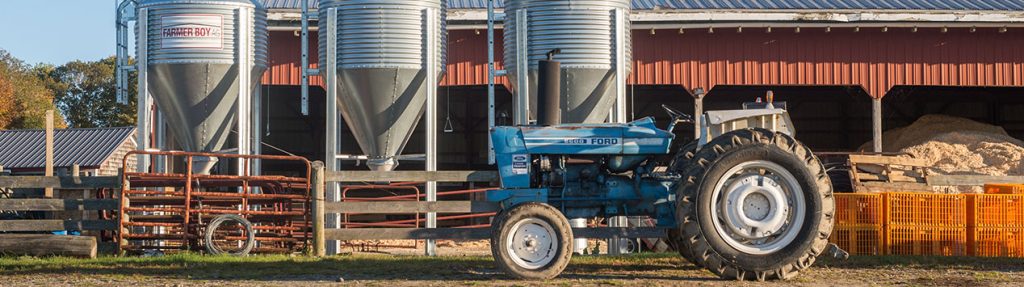 barn, grain silos, and tractor on Maine farm