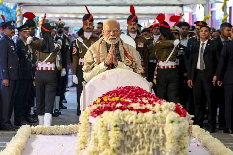 In this handout photograph taken on December 28, 2024 and released by the Indian Press Information Bureau (PIB), India's Prime Minister Narendra Modi (C) pays last respect to his late predecessor Manmohan Singh during the state funeral ceremony in New Delhi. India on December 28, accorded former premier Manmohan Singh, one of the architects of the country's economic liberalisation in the early 1990s, a state funeral with full military honours, complete with a gun salute. (Photo by Indian Press Information Bureau (PIB) / AFP) / RESTRICTED TO EDITORIAL USE - MANDATORY CREDIT 