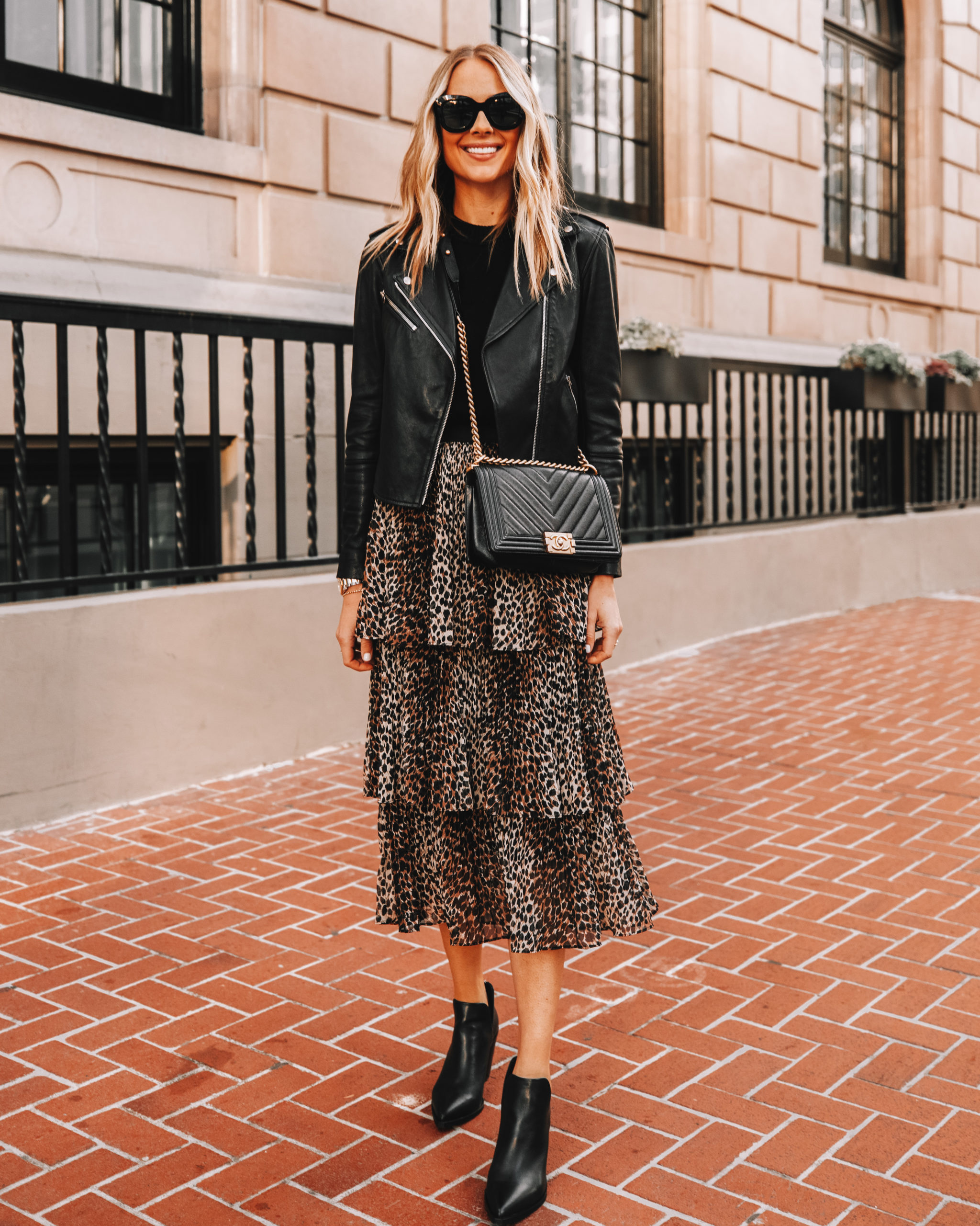 Fashion Jackson Wearing Black Leather Jacket Black Leopard Midi Skirt Black Booties Black Chanel Boy Bag