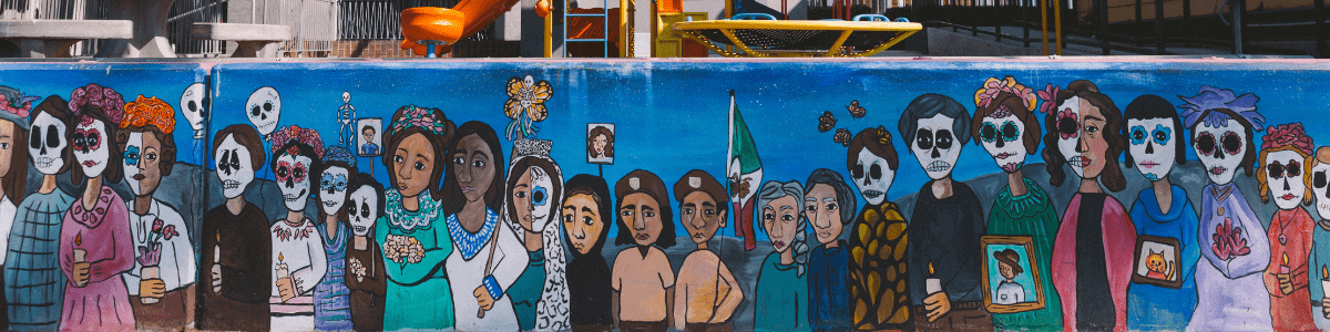 A mural showing a procession for Dia de los Muertos