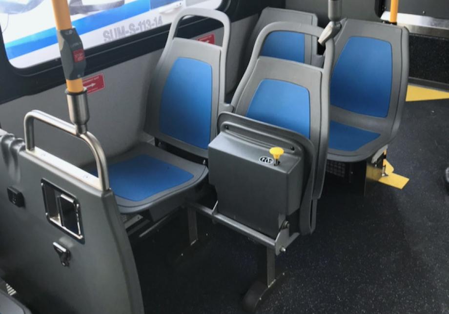 two forward-facing seats on the curbside of the bus. The window seat is stationary, while the aisle seat is flipped up.