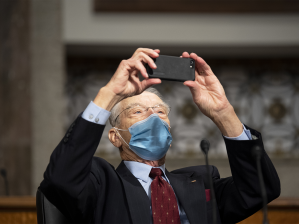 Sen. Chuck Grassley, R-Iowa, takes a cell phone photo