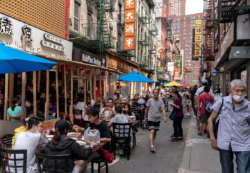 FILE PHOTO: People sit in an outdoor dining area in Manhattan's Chinatown district in New York City