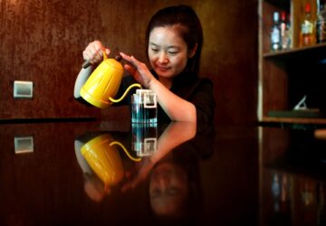 FILE PHOTO: A barista makes drip coffee at the La Tercera cafe in Beijing, China May 6, 2017. REUTERS/Thomas Peter/File Photo