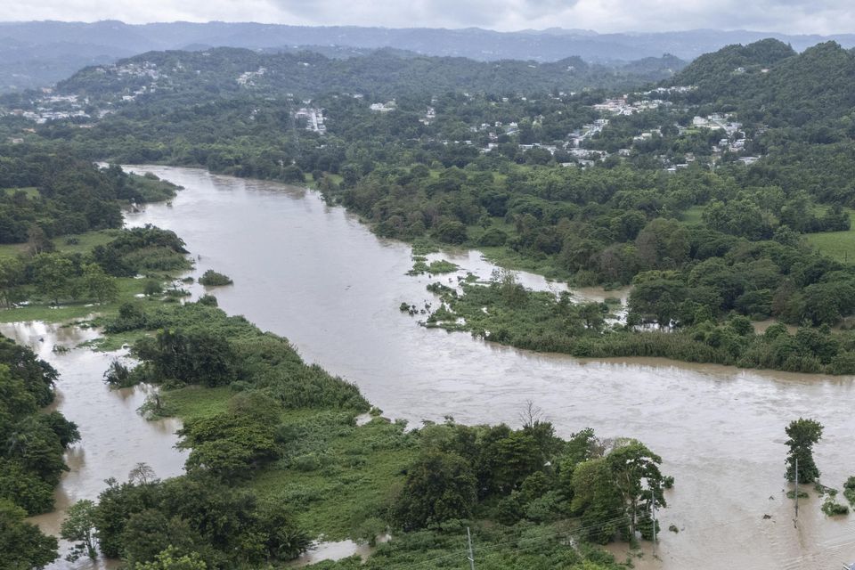 La Plata river floods a road after Tropical Storm Ernesto passed through Toa Baja, Puerto Rico (Alejandro Granadillo/AP/PA)