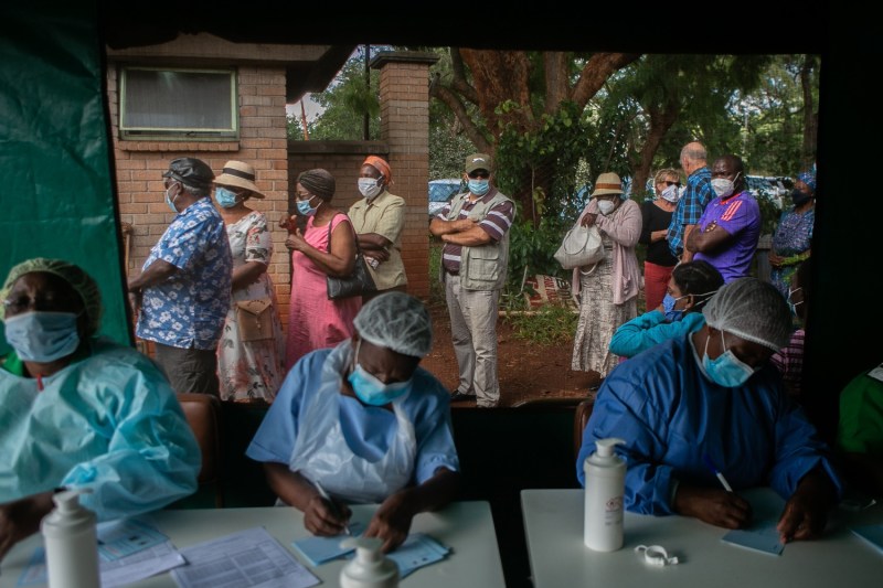 Older people queue for the Sinopharm COVID-19 vaccine outside a tent as nurses work at a local hospital in Harare, Zimbabwe, on March 29.