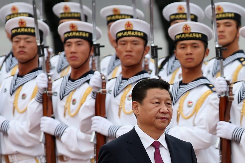 Chinese President Xi Jinping walks past an honor guard of People's Liberation Army sailors at the Great Hall of People in Beijing on Sept. 16, 2013.