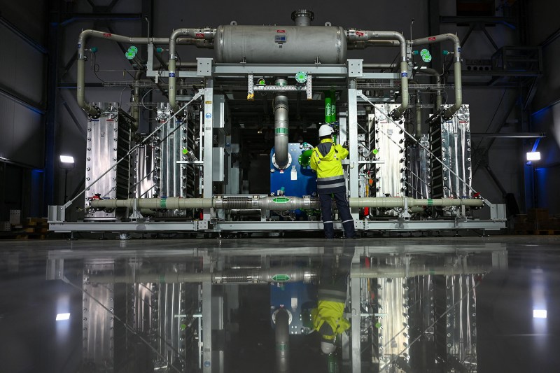 An employee of Air Liquide in front of an electrolyzer at the company's future hydrogen production facility of renewable hydrogen in Oberhausen, Germany.