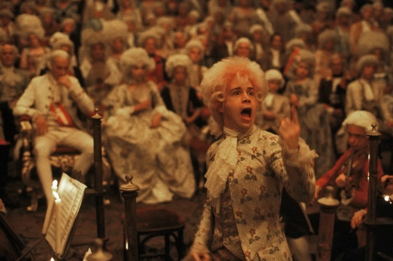 Tom Hulce as Mozart performing in front of a large crowd in a screen grab from a film.