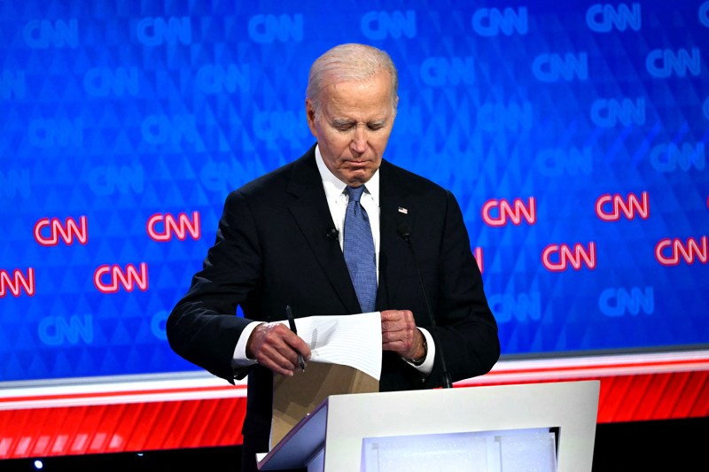 U.S. President Joe Biden takes a look at his notes during the first presidential debate of the 2024 elections in Atlanta, Georgia.