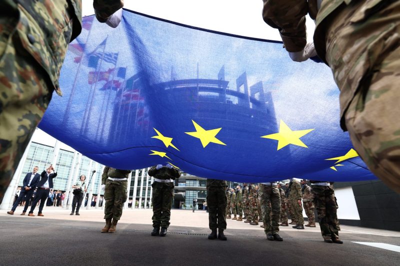 Eurocorps soldiers carry a European Union flag during a flag-raising ceremony in front of the European Parliament building in Strasbourg, France, on July 15.