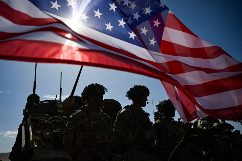 U.S. Army soldiers stand next to a U.S. flag as they take part  in a NATO military exercise at the Novo Selo military ground, Bulgaria, on Sept. 26, 2023.