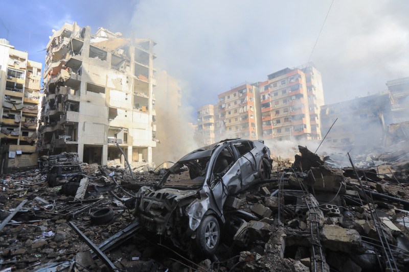 Smoke seeps out from building rubble at the site of an overnight Israeli airstrike on Beirut's southern Laylaki neighborhood.