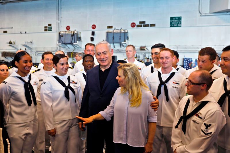 Israeli Prime Minister Benjamin Netanyahu speaks with American soldiers during a visit on the US aircraft carrier, USS George H. W. Bush, as it docks at the Haifa port, on July 3, 2017.