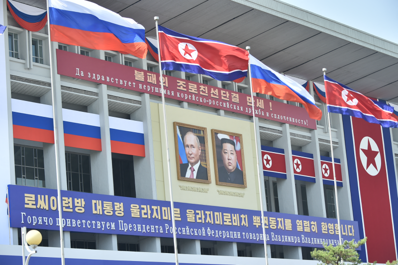 View of portraits of Russian President Vladimir Putin and North Korean leader Kim Jong Un with banners underneath that translate to "Long live the undefeated friendship and unity of DPRK-Russia!" and "We warmly welcome Comrade Vladimir Vladimirovich Putin, the President of the Russian Federation" outside the Pyongyang Indoor Stadium in Pyongyang on June 20.