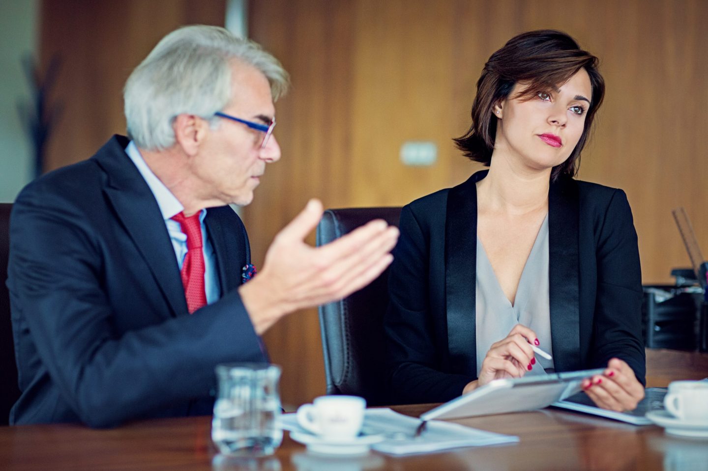 Two executives engage in a tense conversaton