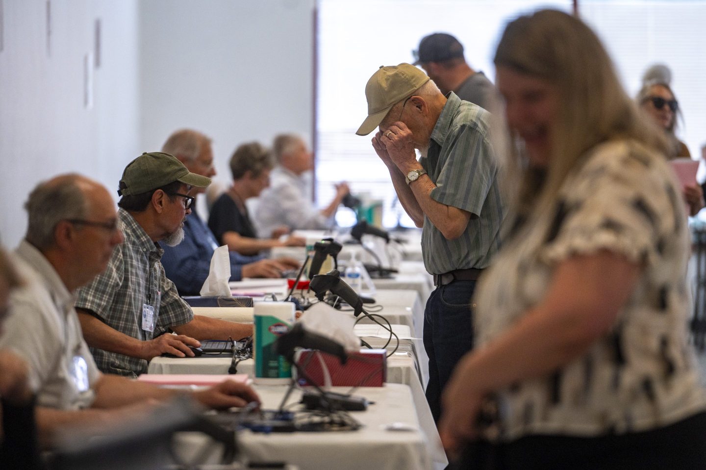 Poll workers help voters at an election center at the Holly Plaza Shopping Center in Albuquerque, N.M., on Tuesday, June 4, 2024. (Jon Austria/The Albuquerque Journal via AP)