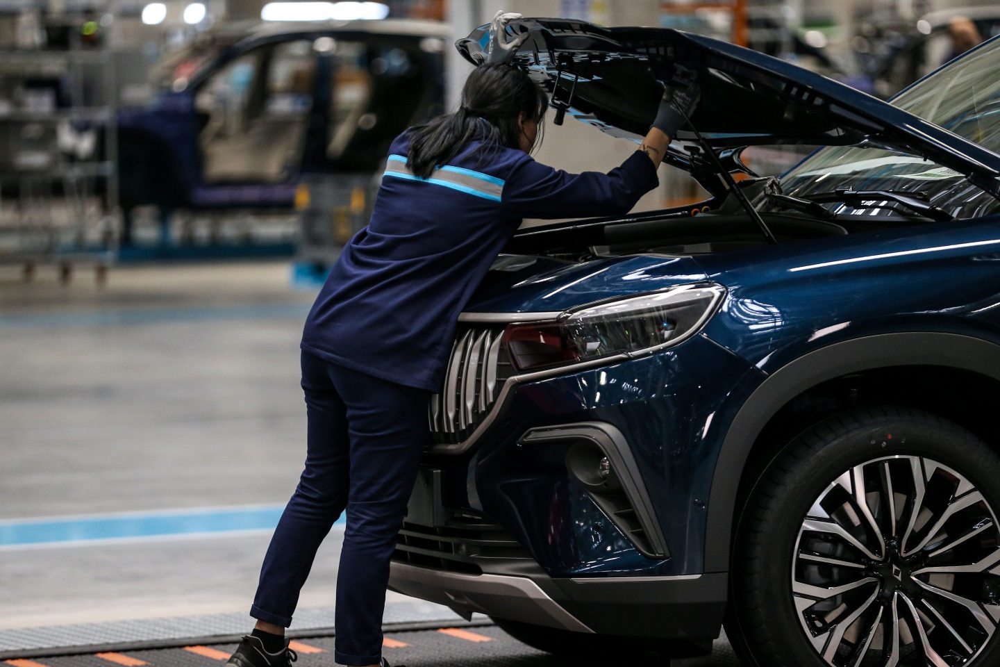 A car mechanic inspecting a vehicle.