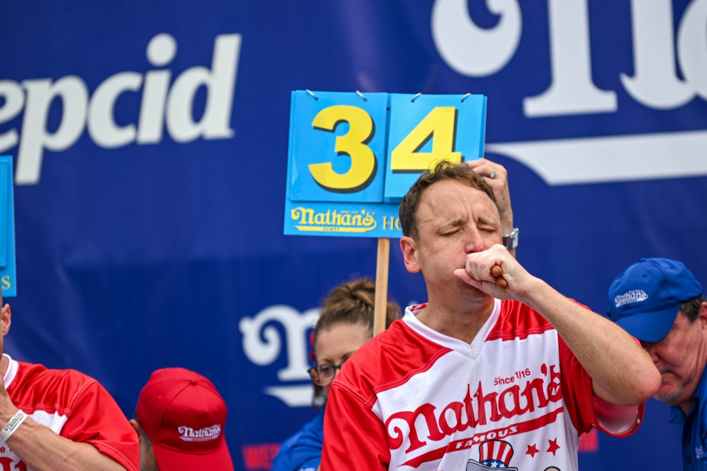 Joey Chestnut holding in his 34th hot dog