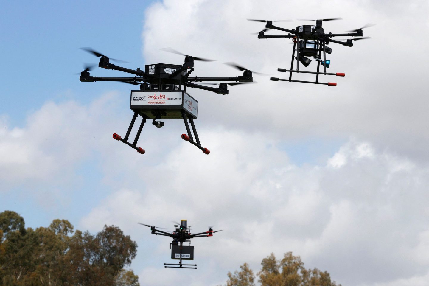 This picture taken on March 17, 2021 in the Israeli coastal city of Hadera shows an unmanned aerial vehicle (UAV, or drone) carrying fast food deliveries (hamburgers) as part of the main demonstration performed by the companies who won the tender for this project. &#8211; Some 20 drones from five different companies will perform about 300 flights per day simultaneously in a mesh network managed by an autonomous control system located at the Ayalon Highways Aerial Control Center in Haifa. (Photo by JACK GUEZ / AFP) (Photo by JACK GUEZ/AFP via Getty Images)