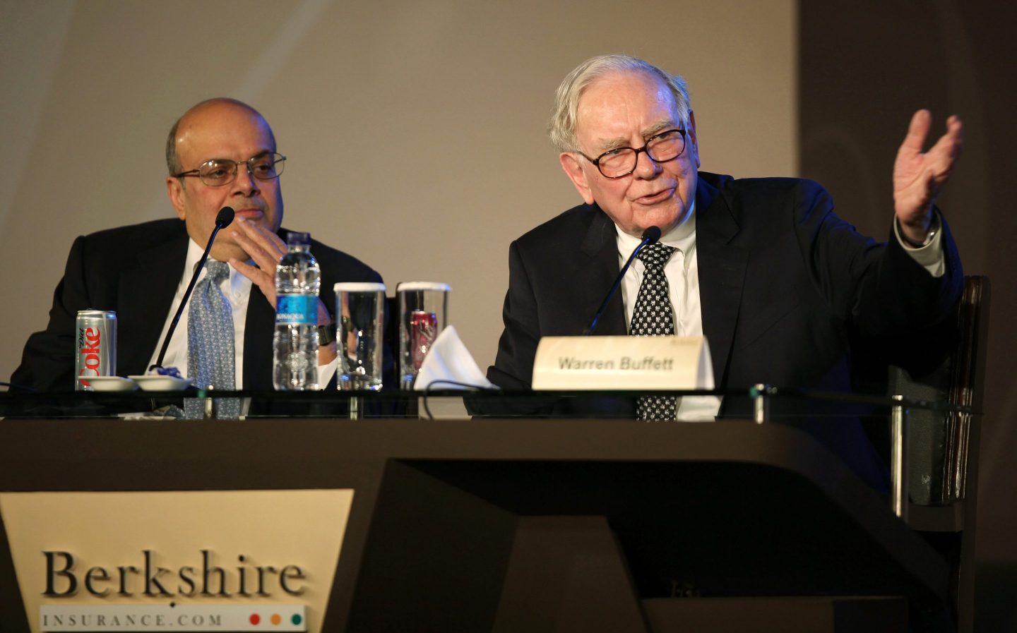 Warren Buffett, chairman and chief executive officer of Berkshire Hathaway Inc., right, speaks at a meeting with insurance customers while Ajit Jain, president of reinsurance division for Berkshire Hathaway Inc., listens in New Delhi, India, on Friday, March 25, 2011. Buffett, the billionaire who urged Congress in 2009 to guard against inflation, said investors should avoid long-term fixed-income bets in U.S. dollars because the currency&#8217;s purchasing power will decline. Photographer: Pankaj Nangia/Bloomberg via Getty Images